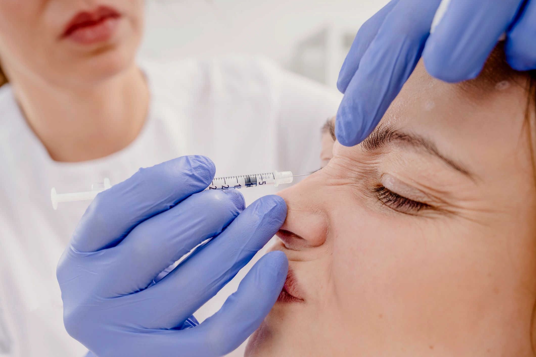 Aesthetic nurse consulting with client in skincare clinic
